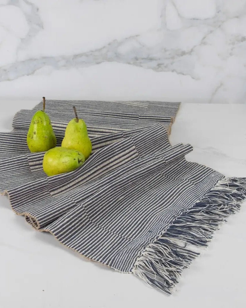 Table runner handloomed textile with pears on a marble surface