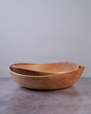 Two TerraKlay contempoary wave wooden bowls on a gray surface with a gray background