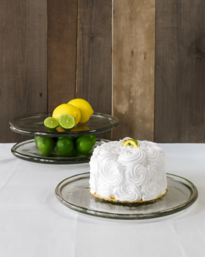 White cake on TerraKlay's glass plate with lemons and limes.