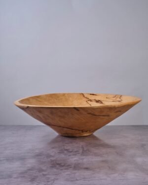 Wooden bowl on a gray surface with a neutral background
